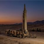 A mobile Iranian ballistic missile launcher prepared for a test in a desert location.